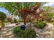 Inviting backyard patio with lush landscaping, paved seating area, and mature trees at 1012 Delta River Way, Knightdale, NC 27545