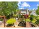 Backyard featuring mature trees, lush landscaping, koi pond, and stone patio at 1012 Delta River Way, Knightdale, NC 27545