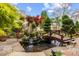 Backyard featuring a serene koi pond with a bridge and a rock waterfall feature at 1012 Delta River Way, Knightdale, NC 27545