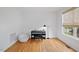 Bright bedroom features hardwood floors, white walls, and a black keyboard against the wall at 1012 Delta River Way, Knightdale, NC 27545