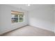A carpeted bedroom with a window providing natural light and a view of the outdoors at 1012 Delta River Way, Knightdale, NC 27545