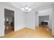 Open-concept dining room featuring hardwood floors, white trim, and a modern chandelier at 1012 Delta River Way, Knightdale, NC 27545