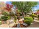 Landscaped garden with brick path, mature trees, and vibrant flower beds creating a serene retreat at 1012 Delta River Way, Knightdale, NC 27545