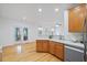 Eat-in kitchen featuring wooden cabinets, white countertops, stainless steel dishwasher, and hardwood floors at 1012 Delta River Way, Knightdale, NC 27545