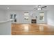 Spacious living area with hardwood floors, fireplace, ceiling fan, and access to outdoor space at 1012 Delta River Way, Knightdale, NC 27545
