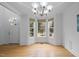 Bright living room featuring hardwood floors, a bay window, and a modern chandelier at 1012 Delta River Way, Knightdale, NC 27545