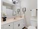 Clean bathroom features a vanity with storage, framed mirror, and decorative accents at 103 Val Del Ct, Garner, NC 27529