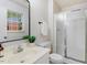 Cozy bathroom featuring a glass-enclosed shower, updated vanity, and a window at 103 Val Del Ct, Garner, NC 27529