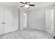 A bright bedroom boasts neutral walls, ceiling fan, and an attached bathroom at 103 Val Del Ct, Garner, NC 27529