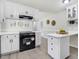 Bright kitchen featuring white cabinets, sleek appliances, and ample counter space at 103 Val Del Ct, Garner, NC 27529