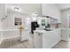 Well-lit kitchen with white cabinets, a built-in breakfast bar, and modern flooring at 103 Val Del Ct, Garner, NC 27529