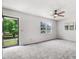 Spacious living room boasts a ceiling fan, plush carpet, and natural light from exterior at 103 Val Del Ct, Garner, NC 27529