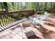 A spacious back deck features outdoor seating, perfect for relaxing and enjoying the wooded views at 103 Westview # H, Carrboro, NC 27510