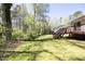 Expansive backyard with a lush lawn and wooded area offers plenty of space for outdoor activities at 103 Westview # H, Carrboro, NC 27510