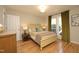 Comfortable bedroom with hardwood floors, a large window, and neutral decor at 103 Westview # H, Carrboro, NC 27510