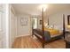 Spacious bedroom with hardwood floors, a four-poster bed, and ample natural light at 103 Westview # H, Carrboro, NC 27510