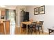 Cozy dining area with a wooden table, black chairs, and a view into the kitchen space at 103 Westview # H, Carrboro, NC 27510