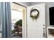 Inviting front door with a wreath, and a glimpse of the entryway's bright interior at 103 Westview # H, Carrboro, NC 27510
