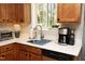 Bright kitchen featuring wood cabinets, stainless steel appliances, and a window overlooking the backyard at 103 Westview # H, Carrboro, NC 27510