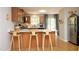 Bright kitchen with stainless steel appliances, white countertops, and wooden bar stools at 103 Westview # H, Carrboro, NC 27510