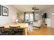Open-concept living room and dining area, featuring hardwood floors and neutral décor at 103 Westview # H, Carrboro, NC 27510