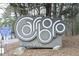 Carrboro Wilson Park sign amidst trees, displaying park rules and regulations at 103 Westview # H, Carrboro, NC 27510