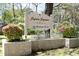 The 'Sylvia Square' community sign surrounded by flower beds offers a warm welcome at 103 Westview # H, Carrboro, NC 27510
