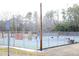 Well-maintained tennis courts surrounded by fencing and trees provide an active recreational space at 103 Westview # H, Carrboro, NC 27510