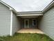 Back patio featuring gray siding and a covered seating area at 104 Oakfield Trace Dr, Four Oaks, NC 27524