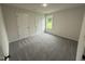 Bedroom with neutral carpet, natural light and two doors at 104 Oakfield Trace Dr, Four Oaks, NC 27524