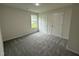 Bedroom with neutral carpet, natural light and two doors at 104 Oakfield Trace Dr, Four Oaks, NC 27524