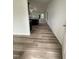 Spacious hallway with modern flooring, leading to the living spaces and filled with natural light at 104 Oakfield Trace Dr, Four Oaks, NC 27524