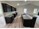 Modern kitchen featuring dark cabinets, light granite countertops, stainless appliances and a large island at 104 Oakfield Trace Dr, Four Oaks, NC 27524