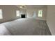 Inviting living room with a fireplace, plush carpet, and large windows offering plenty of natural light at 104 Oakfield Trace Dr, Four Oaks, NC 27524