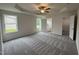 Spacious main bedroom with tray ceilings, plush carpet, and a ensuite bathroom with a soaking tub at 104 Oakfield Trace Dr, Four Oaks, NC 27524