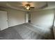 Large main bedroom with tray ceiling, ceiling fan, plush carpet, and access to an ensuite bathroom at 104 Oakfield Trace Dr, Four Oaks, NC 27524
