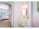 Charming bathroom with a white vanity, framed mirror and a view into the bedroom space at 109 Jasmine Rose Ct, Holly Springs, NC 27540