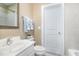 Cozy bathroom with tile flooring, a traditional mirror, and a toilet with shelving at 109 Jasmine Rose Ct, Holly Springs, NC 27540
