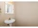 Powder room features a pedestal sink, framed medicine cabinet and neutral colored walls at 109 Jasmine Rose Ct, Holly Springs, NC 27540