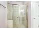 Bathroom showcasing tiled shower with glass doors and accessibility features like a grab bar at 109 Jasmine Rose Ct, Holly Springs, NC 27540