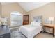 Comfortable bedroom with a vaulted ceiling, large window, and simple elegant furnishings at 109 Jasmine Rose Ct, Holly Springs, NC 27540