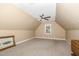 Spacious bedroom featuring neutral carpet, a ceiling fan, and a window for natural light at 109 Jasmine Rose Ct, Holly Springs, NC 27540