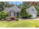 Charming home featuring stone accents, mature trees, and a lush, well-maintained lawn at 109 Jasmine Rose Ct, Holly Springs, NC 27540