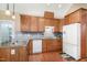 Functional kitchen with wooden cabinets, tile backsplash, and stainless-steel appliances at 109 Jasmine Rose Ct, Holly Springs, NC 27540