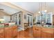 Open kitchen featuring wood cabinets, granite counters, hardwood floors, and lots of natural light at 109 Jasmine Rose Ct, Holly Springs, NC 27540