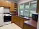Efficient kitchen with a white refrigerator and oven, ample counter space, and a large window at 109 Jasmine Rose Ct, Holly Springs, NC 27540