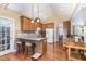 Well-equipped kitchen with wooden cabinets, modern appliances, and breakfast bar at 109 Jasmine Rose Ct, Holly Springs, NC 27540