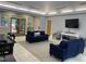Inviting living room with comfortable seating, a large TV, and natural light from the outside at 109 Jasmine Rose Ct, Holly Springs, NC 27540