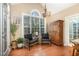 Cozy sitting area with a large window, chandelier, and wooden cabinet in the main living space at 109 Jasmine Rose Ct, Holly Springs, NC 27540