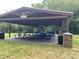Community pavilion with picnic tables and garbage cans, perfect for outdoor gatherings at 109 Jasmine Rose Ct, Holly Springs, NC 27540